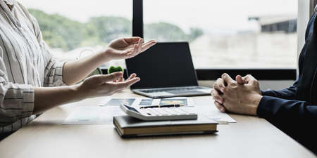 Meeting room atmosphere between the business partners who formed a startup company, they are having a brainstorming meeting together to plan the company's management. New business concept.の写真素材