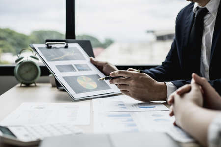 Two businessmen are meeting together on the topic of monthly finance, financial documents prepared by the finance department. Concept of financial management according to company policy.の写真素材