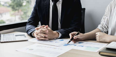 Two businessmen are reviewing monthly sales documents for analysis and marketing plans for more sales growth, they are the founders of young companies co-founding startups. Sales management concept.の写真素材