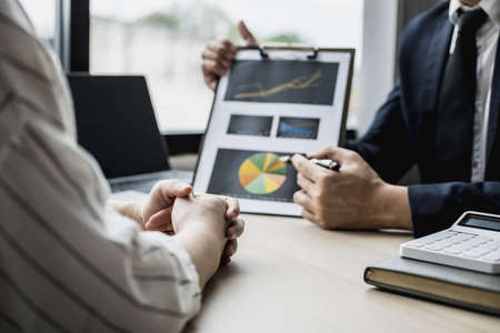 Two businessmen are meeting together on the topic of monthly finance, financial documents prepared by the finance department. Concept of financial management according to company policy.の写真素材