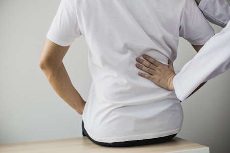 Professional physiotherapists are working to relax the muscles for patients who are treated for muscle disorders, most patients are office workers who sit for a long time causing pain. office syndromeの写真素材