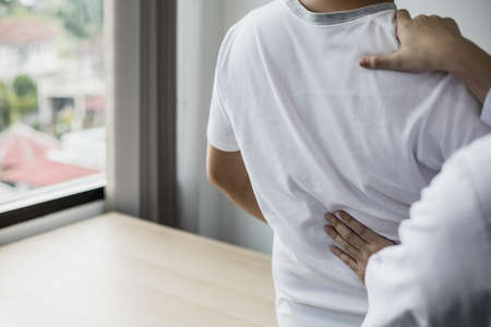 Professional physiotherapists are working to relax the muscles for patients who are treated for muscle disorders, most patients are office workers who sit for a long time causing pain. office syndromeの写真素材