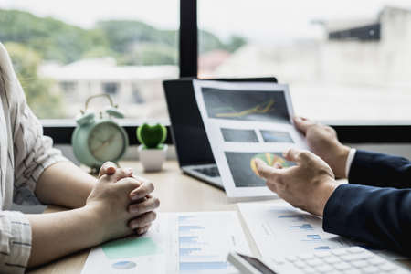 Two businessmen are meeting together on the topic of monthly finance, financial documents prepared by the finance department. Concept of financial management according to company policy.の写真素材