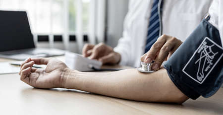 The doctor shows a document informing the results of the examination, the doctor explains the results of the tests found and treatment guidelines. Concept of examination and treatment of disease.の写真素材