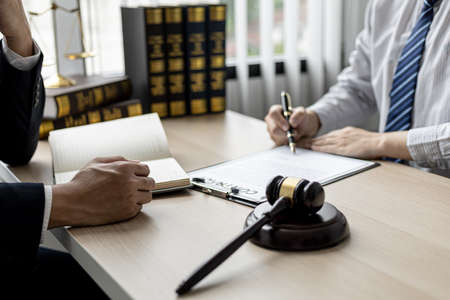 Attorneys or lawyers are advising clients in defamation cases, they are collecting evidence to bring charges against the parties for damages. The concept of defamation case counseling.の写真素材