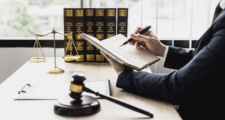 A lawyer man is seeking information on a fraud case to bring to court in a lawsuit from which a client has filed a lawsuit against an employee at a company that commits fraud. Fraud litigation conceptの写真素材