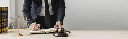A lawyer man is seeking information on a fraud case to bring to court in a lawsuit from which a client has filed a lawsuit against an employee at a company that commits fraud. Fraud litigation conceptの写真素材