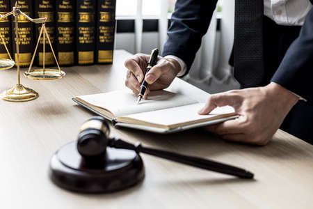 A lawyer man is seeking information on a fraud case to bring to court in a lawsuit from which a client has filed a lawsuit against an employee at a company that commits fraud. Fraud litigation conceptの写真素材