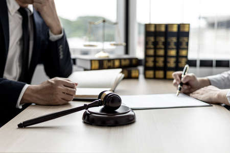 Attorneys or lawyers are advising clients in defamation cases, they are collecting evidence to bring charges against the parties for damages. The concept of defamation case counseling.の写真素材