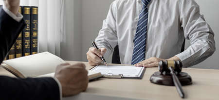 Attorneys or lawyers are advising clients in defamation cases, they are collecting evidence to bring charges against the parties for damages. The concept of defamation case counseling.の写真素材