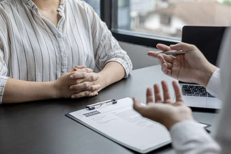 The HR department is explaining in detail the recruitment qualification for the position of the applicant's interest. and check resume applications. The concept of personnel allocation to work.の写真素材
