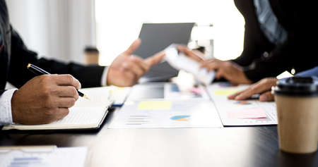 Executives and managers are meeting in a conference room, on the table there are some documents about the company's finances, managers are discussing financial information with the management.の写真素材