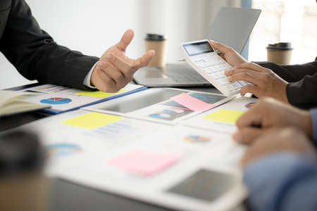 Executives and managers are meeting in a conference room, on the table there are some documents about the company's finances, managers are discussing financial information with the management.の写真素材