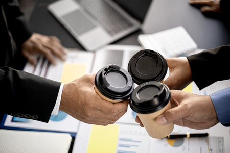 Close-up of three business men colliding with hot coffee cups after the meeting, business men gather...