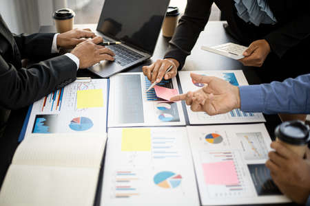 Executives and managers are meeting in a conference room, on the table there are some documents about the company's finances, managers are discussing financial information with the management.の写真素材