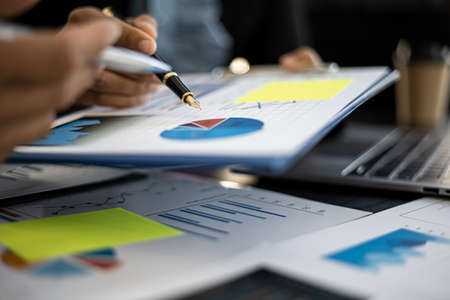 A meeting between two partners on corporate finance and together brainstorming for the company to grow, they are looking at the conference materials in the form of a chart, Financial concept.の写真素材