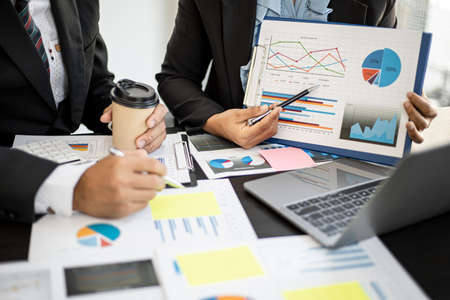 A meeting between two partners on corporate finance and together brainstorming for the company to grow, they are looking at the conference materials in the form of a chart, Financial concept.の写真素材