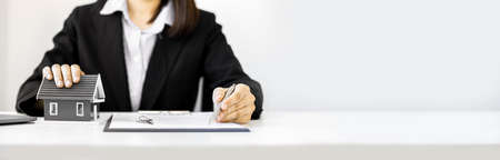 The home salesman and buyer is signing a purchase agreement after discussing the details, a contract to protect both parties' interests if the trade is not as agreed, Real estate trading ideas.の写真素材