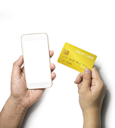 Person is holding a mobile phone in his left hand and right hand is holding a gold credit card, Isolated on white backgroundの写真素材