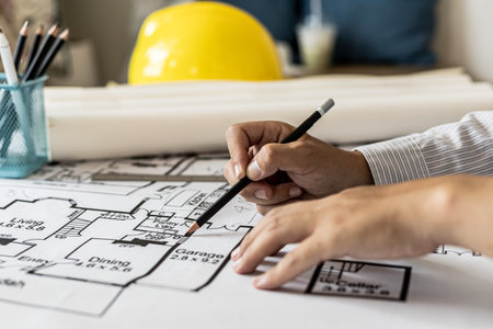 Architects write on the blueprints of the designed houses, designing the buildings according to the standards and the law, designing the houses according to the needs of the residents.の写真素材