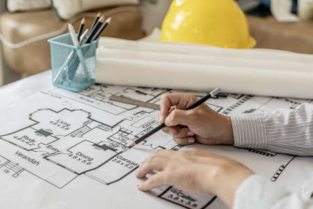 Architects write on the blueprints of the designed houses, designing the buildings according to the standards and the law, designing the houses according to the needs of the residents.の写真素材