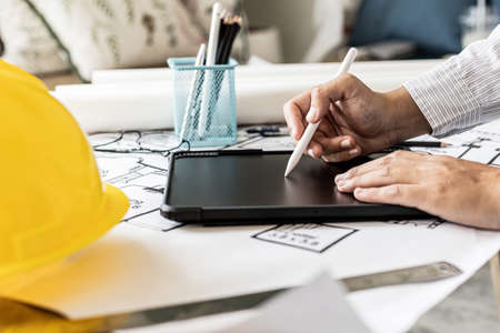 Architects are drawing house design blueprints, designing the house according to the needs of the...