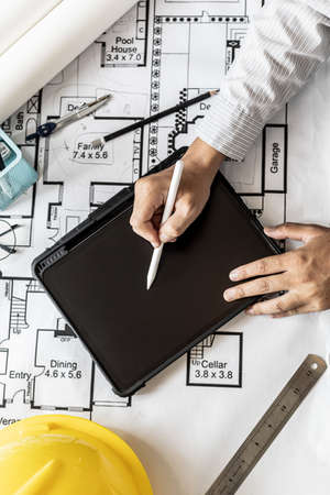 Architects are drawing house design blueprints, designing the house according to the needs of the homeowner and in accordance with the construction standards. Home design ideas.の写真素材