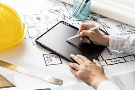 Architects are drawing house design blueprints, designing the house according to the needs of the homeowner and in accordance with the construction standards. Home design ideas.の写真素材