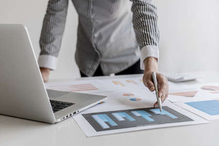 The auditor points to the financial statement, she examines the financial information from the...