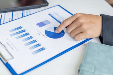 Business men are looking at the company's financial documents to analyze problems and find solutions...