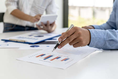 The sales department is having a monthly summary meeting to bring it to the department manager, they are verifying the correctness of the documents that are prepared before bringing in to the managerの写真素材