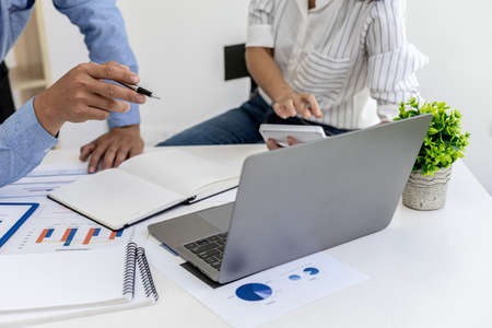 The sales department is having a monthly summary meeting to bring it to the department manager, they are verifying the correctness of the documents that are prepared before bringing in to the managerの写真素材