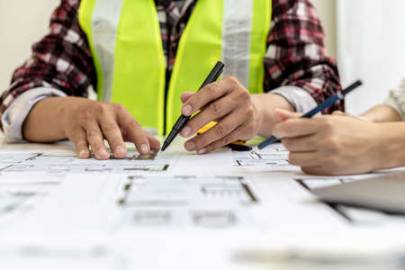 Two architect-engineers are consulting to modify the blueprints of the contracted house, they have a...