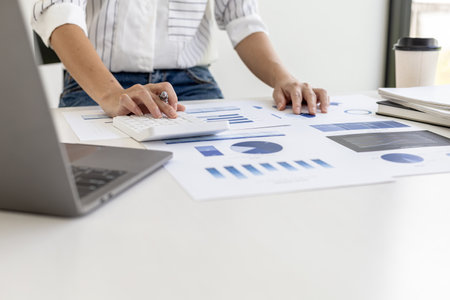 financial business woman pressing a white calculator, she uses a calculator to calculate the numbers...
