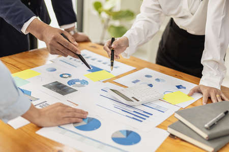 Executives and managers are meeting in a conference room, on the table there are some documents about the company's finances, managers are discussing financial information with the management.の写真素材