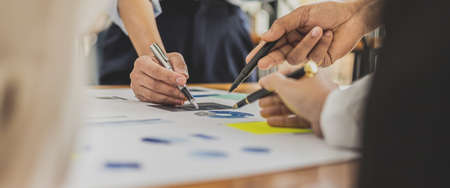 Executives and managers are meeting in a conference room, on the table there are some documents about the company's finances, managers are discussing financial information with the management.の写真素材