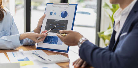 Atmosphere of a startup company meeting, business people are meeting together to summarize and plan investment finances, they are the founders of the company. Business administration concept.の写真素材