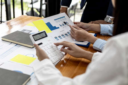 Meeting room atmosphere of a startup company, the finance department is meeting with executives to present financial programs, brainstorming sessions. Concept of company financial management.の写真素材