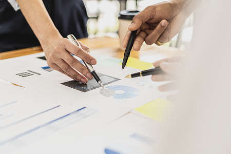 Executives and managers are meeting in a conference room, on the table there are some documents about the company's finances, managers are discussing financial information with the management.の写真素材