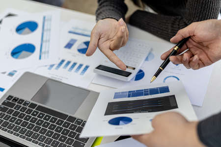 The sales department is having a monthly summary meeting to bring it to the department manager, they are verifying the correctness of the documents that are prepared before bringing in to the managerの写真素材