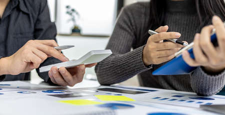 The atmosphere in the meeting room where businessmen and business partners are meeting together,...