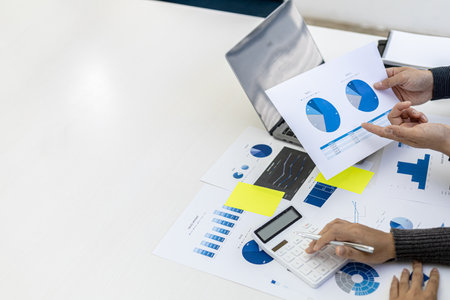 A conference room where executives and marketers are looking at sales documents to analyze, plan marketing and do sales promotions, they are brainstorming. Sales management concept.の写真素材