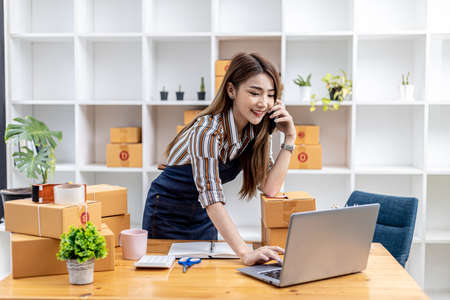 Employees are writing customer shipments to order products through online websites and deliver products through private transportation services. Product sales concepts online. copy space.の写真素材