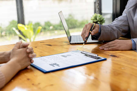 The HR department is reviewing the resumes of job applicants, resumes are important documents for job application. It should contain resume, training history, education, talent, work skills, etc.の写真素材