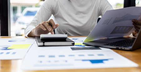 The company's finance manager is using a calculator, he uses a calculator to calculate the numbers...