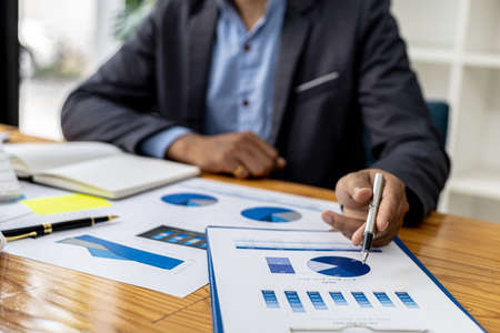 The sales department is having a monthly summary meeting to bring it to the department manager, they are verifying the correctness of the documents that are prepared before bringing in to the managerの写真素材