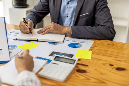 The sales department is having a monthly summary meeting to bring it to the department manager, they are verifying the correctness of the documents that are prepared before bringing in to the managerの写真素材