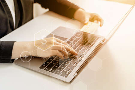 Women are typing credit card information on their tablets to pay for items purchased through online...