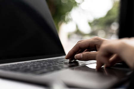 A business women working in a private room, She is typing on a laptop keyboard, She uses a messenger...