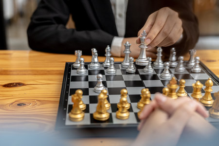 Two people playing a game of chess, concept image of two businessmen playing chess compared to a business competition that requires strategic planning and risk-based business management.の写真素材
